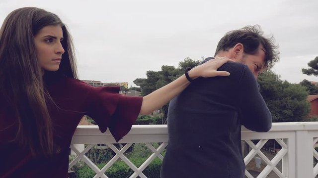 Woman forgiving boyfriend hugging him tight slow motion