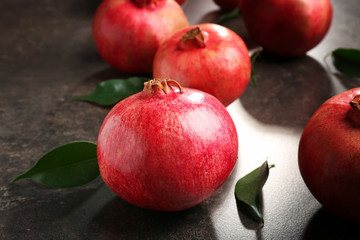 Whole pomegranates on gray background