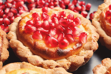 Tasty tart with fresh seeds of pomegranates, closeup