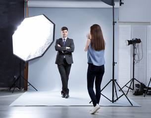 Model posing for professional photographer at studio