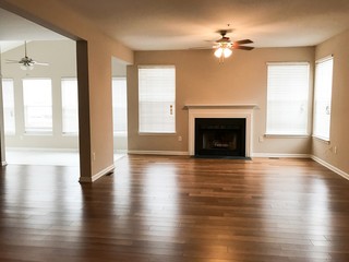 Modern living space with hardwood floors and fireplace