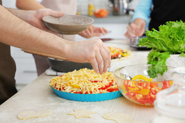 Male hands cooking tasty pie, closeup