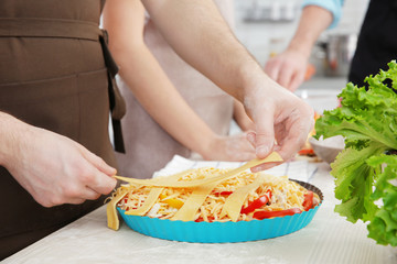 Male hands cooking tasty pie, closeup