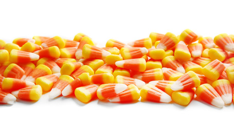 Colorful Halloween candy corns on white background