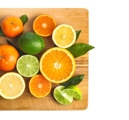 Wooden board with delicious citrus fruits on white background
