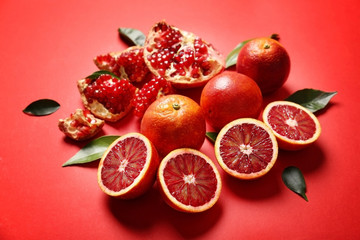 Juicy composition of tropical fruits on red background