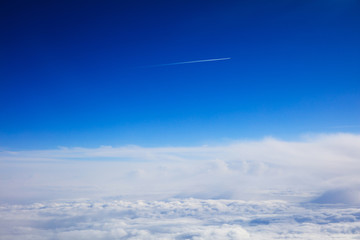 Fototapeta premium Blue sky and clouds - view from plane window