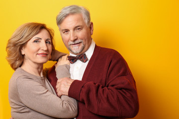 Happy senior couple on color background © Africa Studio