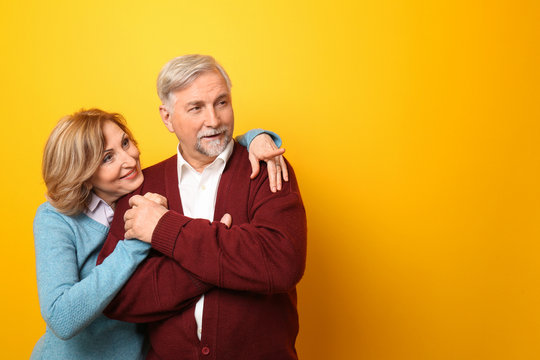 Happy Senior Couple On Color Background