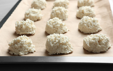 Baking tray with delicious coconut macaroons on table