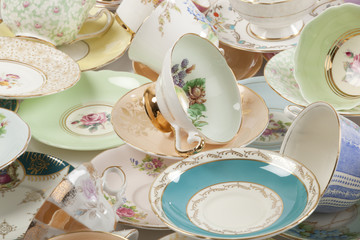 High resolution close-up of a beautiful antique tea cups and saucers collection, isolated on a...