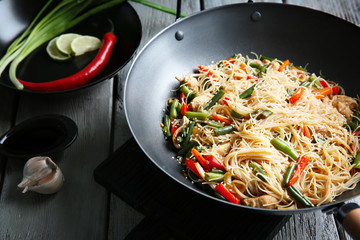 Delicious rice noodle with vegetables on wooden table