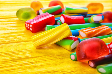 Tasty jelly candies on wooden background, closeup