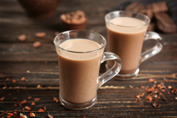 Glass cups of cocoa on wooden table