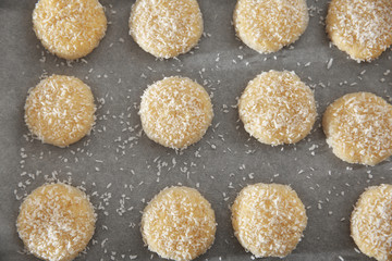 Tasty coconut cookies on parchment paper