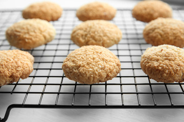 Delicious coconut cookies on baking rack, closeup