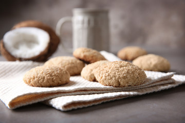 Delicious coconut cookies on light napkins against blurred background