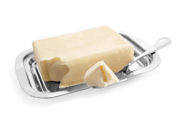 Dish with butter and shovel on white background
