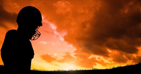 Fototapeta premium Silhouette player wearing sport helmet cloudy 