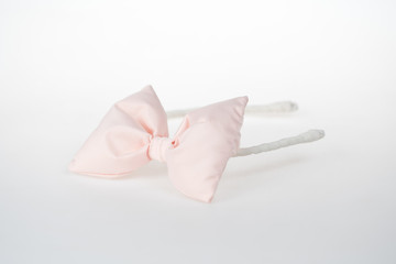 Fashion accessory for little girls with style, creamy bow on white background