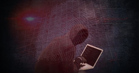 Digital composite image of hacker using laptop 