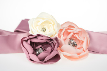 Three hand-made fabric flowers with pearls, belt on an evening dress for special occasions