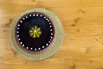 Fototapeta na wymiar Top view of a chocolate cake with pistachio on topping
