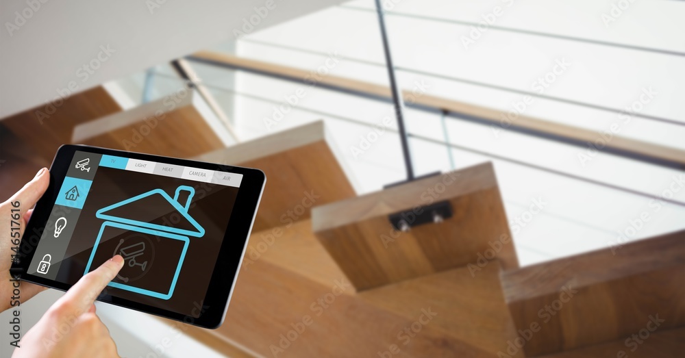 Poster hands using smart home app on tablet pc