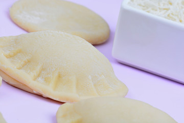 Ravioli with cheese on table