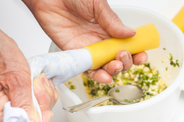 Spinach and cheese cannelloni preparation : Stuffing the cannelloni with the spinach and cheese filling