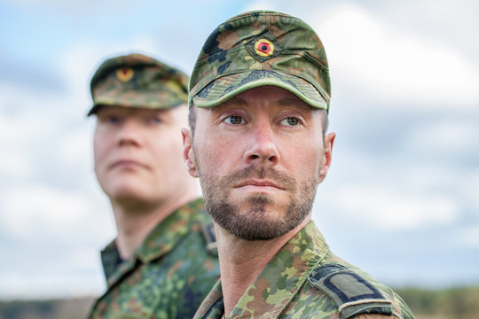 two german soldiers looks to the side