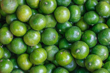 Fresh limes close up background. Healthy food. Harvest in the market, Thailand