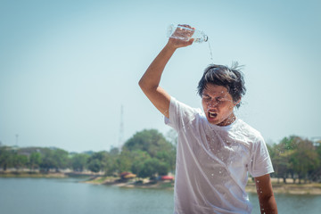 Young man pouring water