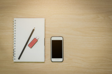 Top view Notebook,smart phone,pencil,flash drive