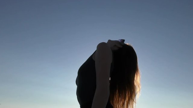 Young attractive woman on the beach at sunset time