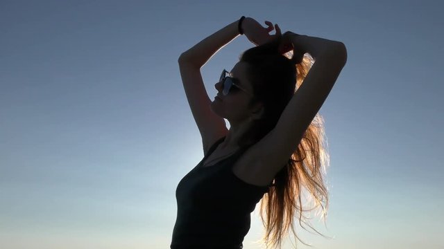 Young attractive woman on the beach at sunset time