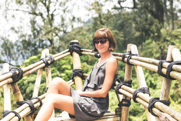 Obraz premium Close-up of beautiful girl posing in tropical forest of magic island Bali, Indonesia.