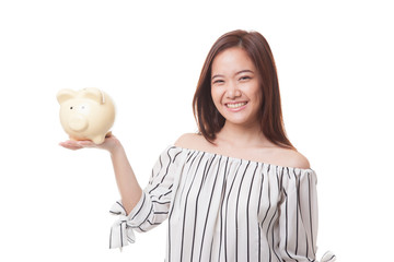 Young Asian woman with a pig coin bank.