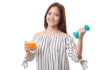 Young Asian woman with dumbbell drink orange juice.