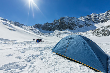 Blue tent in the base camp in the mountains