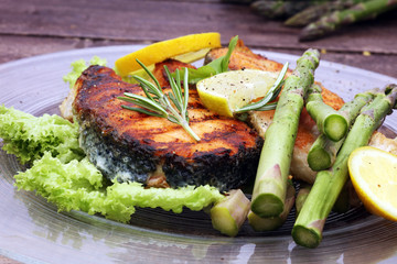 Grilled salmon and asparagus on plate
