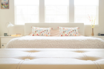 White leather empty bench in front of blurred bedroom