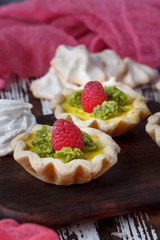 Delicious homemade lemon tart. Pie on rustic white table. Tart with raspberries and meringue