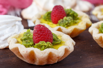 Delicious homemade lemon tart. Pie on rustic white table. Tart with raspberries and meringue