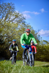 Walking a bike through the forest in the spring.