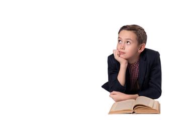 Cute boy in a suit lies and daydreaming on a white background.