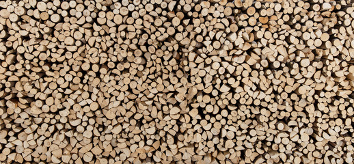 Natural wooden background, many chopped firewood.