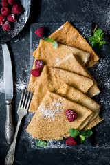 Crepes with raspberries served on slate