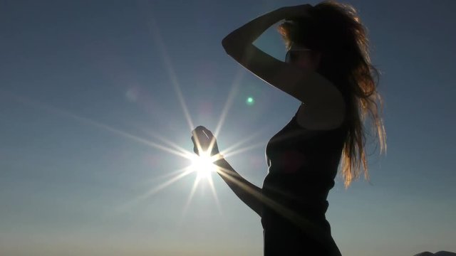 Young attractive woman on the beach at sunset time