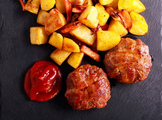Roasted beefsteaks and potatoes with carrot